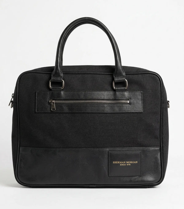 Maletín portafolio Sherman Morgan negro de lona con detalles en vinipiel, bolso ejecutivo para laptop con bolsillo frontal de seguridad y doble asa reforzada.