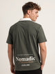 Polo oversize verde, bordado Nomadic Paradise en espalda baja